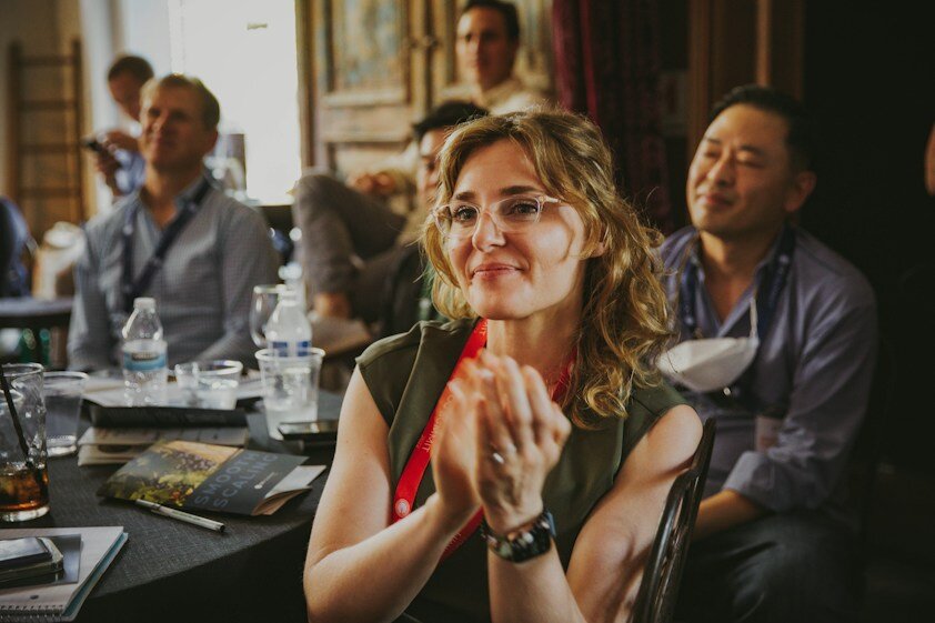 Conference attendee applauding during a talk